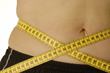 Female belly with tape measure